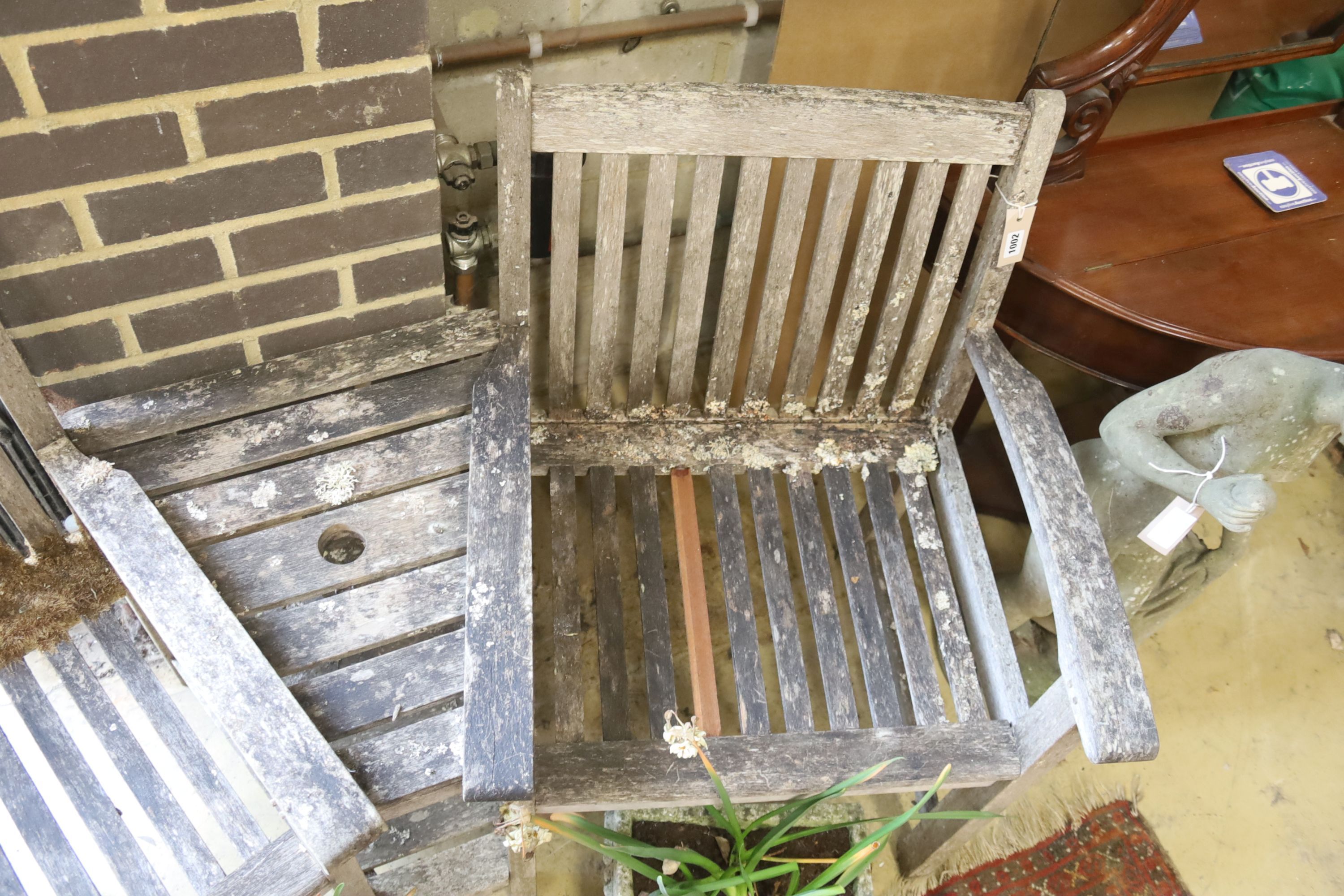 A weathered teak garden love seat, length 155cm, depth 70cm, height 88cm